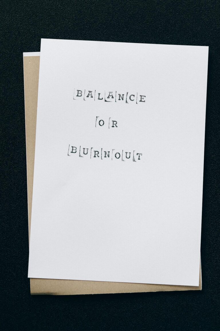 A simple card displaying the message 'Balance or Burnout' emphasizing mental health and stress management.
